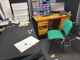 a desk with a computer and a chair in a room