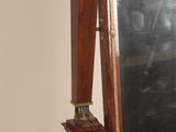 a mirror that is sitting on a stand next to a pair of shoes