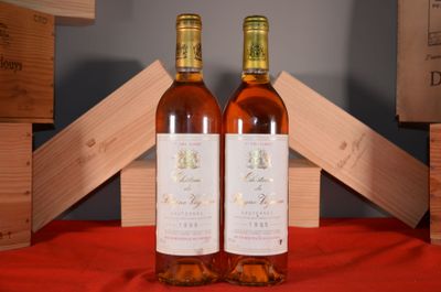 two bottles of wine sitting next to each other on a table