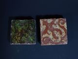 two soap bars sitting on top of a black table