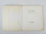an open book sitting on top of a white table next to a white wall