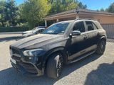 the mercedes gle is parked in front of a building