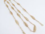 three gold chain necklaces on a white background