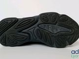 a close up of a pair of black shoes on a white surface