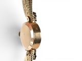 an image of a close up of a wrist watch on a white surface