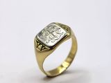 a close up of a gold ring with a diamond on it