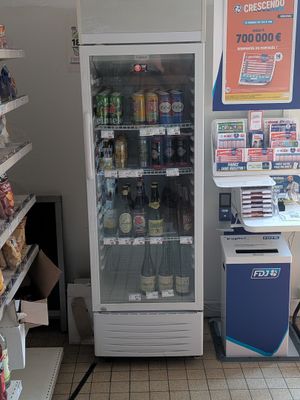 a vending machine in a grocery store with a lot of food