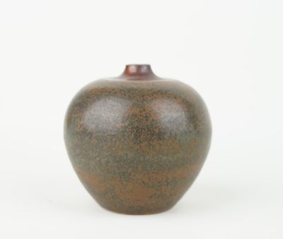 a brown vase sitting on a white surface with a white background