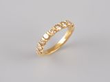 a yellow gold ring with five diamonds on a white background