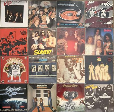 many different album covers on the wall of a room