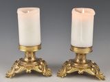 pair of antique brass candle holders with white candles