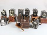 a lot of old cameras sitting on top of each other