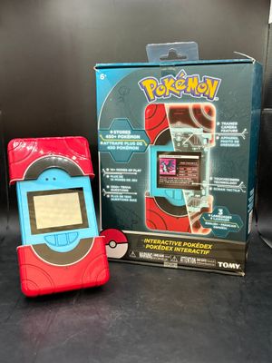 a pokemon cell phone next to a box on a table