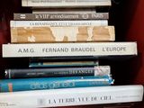 many books stacked on top of each other in a red box