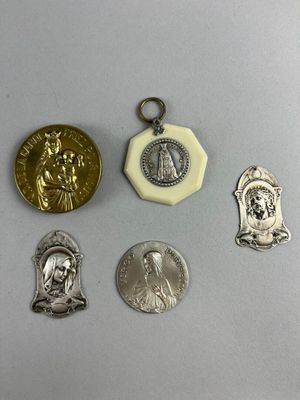 four silver and gold medals and a medal on a white surface