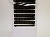 a small white air conditioner sitting on a white surface