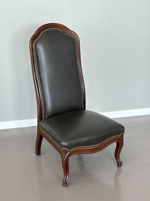fauteuil recouvert de cuir dans une pièce aux murs gris