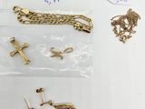 a close up of a bunch of gold jewelry on a table