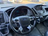 a steering wheel and dashboard of a car in a parking lot