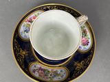 a cup and saucer on a saucer on a table