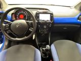 the interior of a small car with a steering wheel and dashboard
