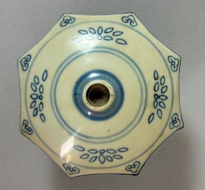 a blue and white plate with a flower design on it