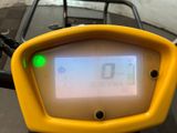 a close up of a yellow motorcycle with a screen on it