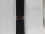 a roll of black yoga mat sitting on top of a white box