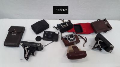 a lot of different types of cameras on a table