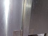 a stainless steel oven with a door open on a tiled floor