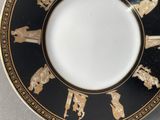 a plate with a black and gold design on it