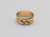 a close up of a gold ring on a white surface
