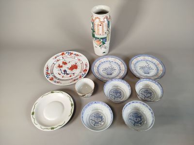 many plates and cups and a vase on the table