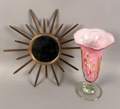 a vase and a sunburst on a table