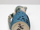 a blue and white vase sitting on a white table