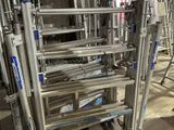 many metal ladders that are on the floor in a room