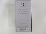 packaging of a bottle of perfume sitting on top of a white table