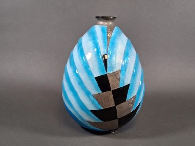 a blue vase with a black and white design on it