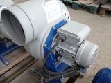 a blue and white blower sitting on a pallet in a warehouse