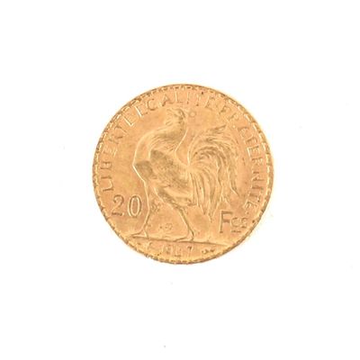 une pièce d'or sur laquelle est représenté un coq