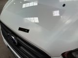 a close up of the hood of a car with a sticker on it