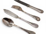 four forks and two spoons on a white surface