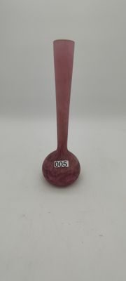 a pink glass vase with a silver base on a white surface