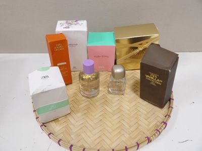 many different perfumes on a tray on a table