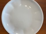 a white plate sitting on a wooden table