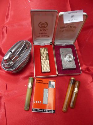 a box with a lighter, lighter and other items on a red cloth