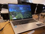 a laptop computer sitting on top of a box in a room