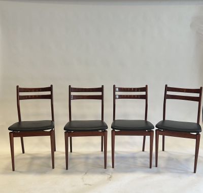 a set of four danish dining chairs with black leather seats