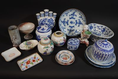 a lot of blue and white dishes and cups on a table