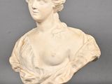 marble bust of a woman wearing a dress and a hat